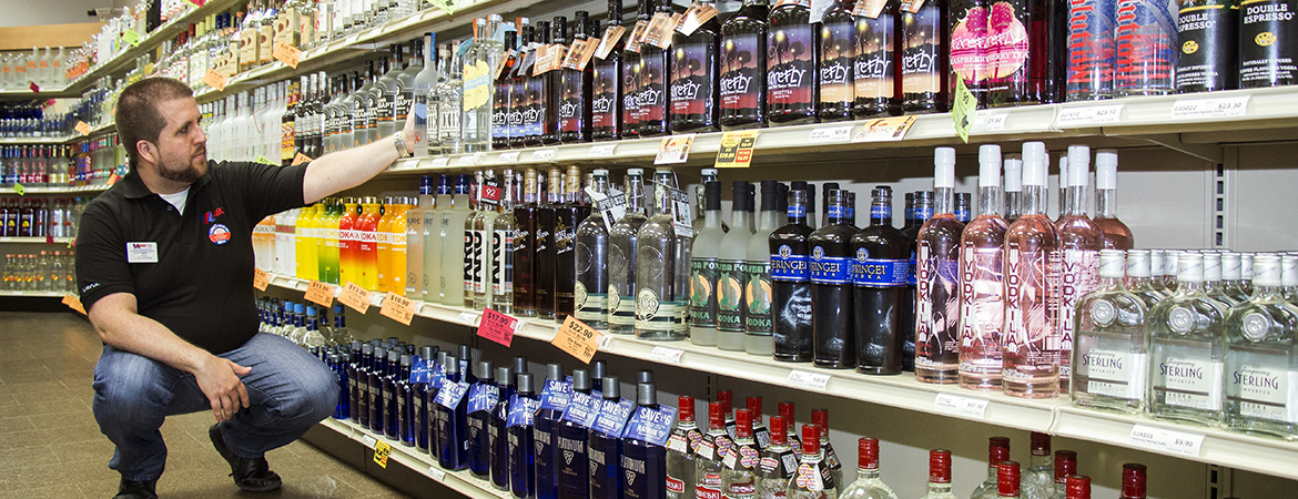 A store employee stocking a shelf at a Virginia ABC store. 