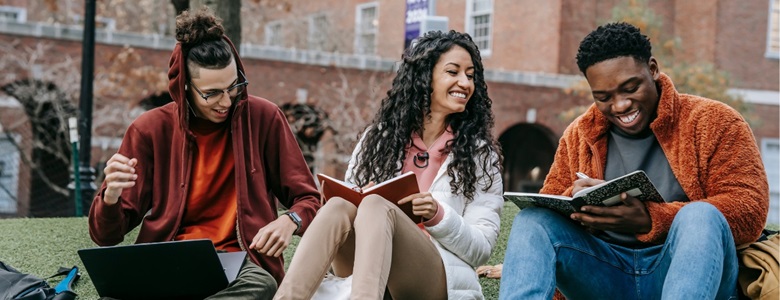 Group of young adults reading books and laughing