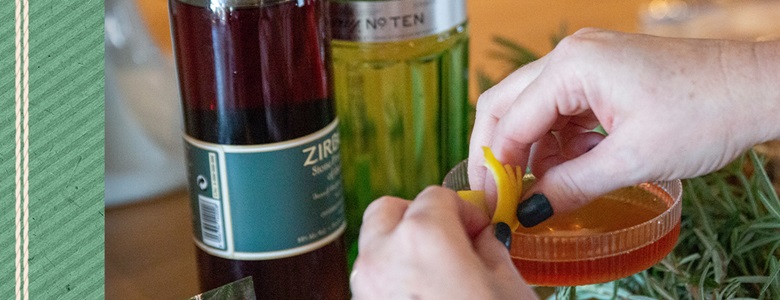 Image of woman adding garnish to a cocktail