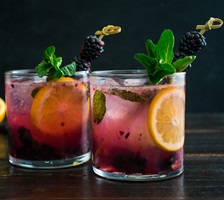 Cocktail with berry and mint garnish
