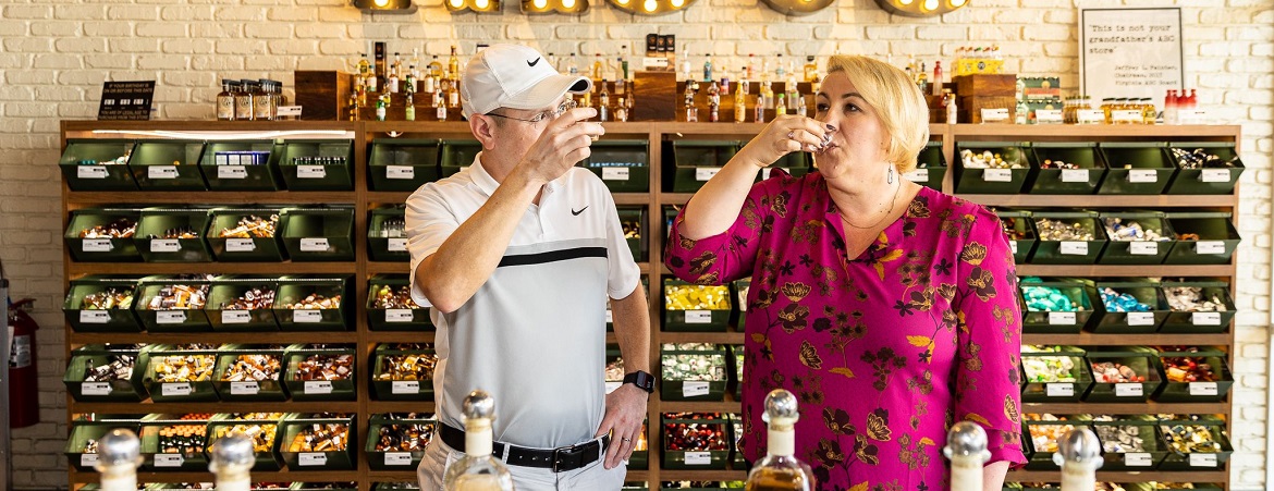 Photo of man and woman tasting a beverage in store